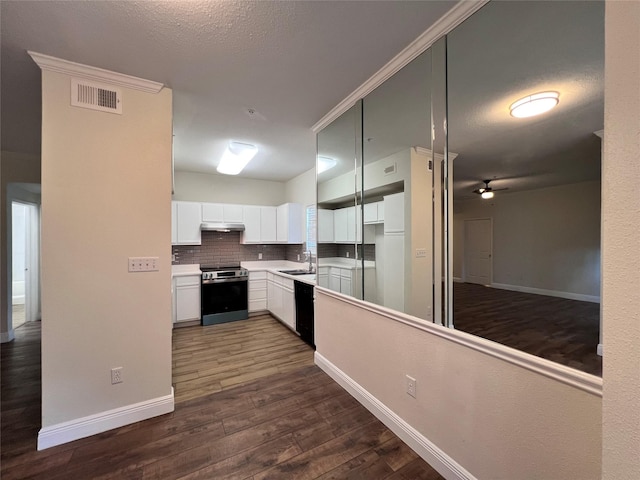 kitchen with visible vents, dark wood finished floors, stainless steel range with electric stovetop, white cabinetry, and a sink