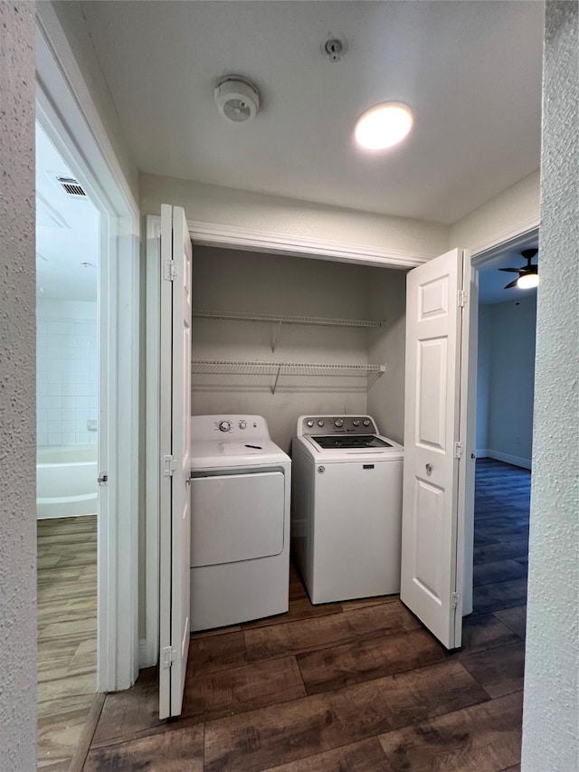 laundry room with independent washer and dryer, laundry area, visible vents, and dark wood-type flooring