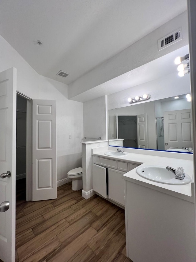 bathroom with visible vents, a sink, and wood finished floors