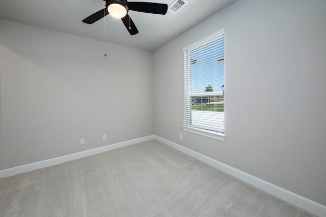 unfurnished room with ceiling fan, baseboards, visible vents, and light carpet