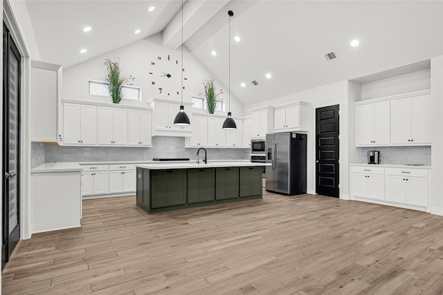 kitchen with visible vents, appliances with stainless steel finishes, light wood-type flooring, and light countertops