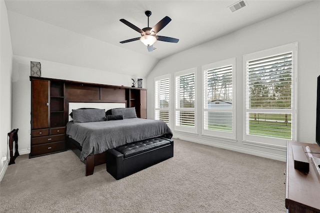 bedroom with a ceiling fan, visible vents, baseboards, vaulted ceiling, and light colored carpet