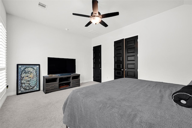 bedroom with lofted ceiling, carpet flooring, a ceiling fan, and visible vents