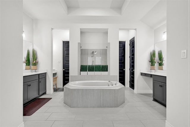 bathroom with baseboards, a garden tub, a shower stall, and vanity