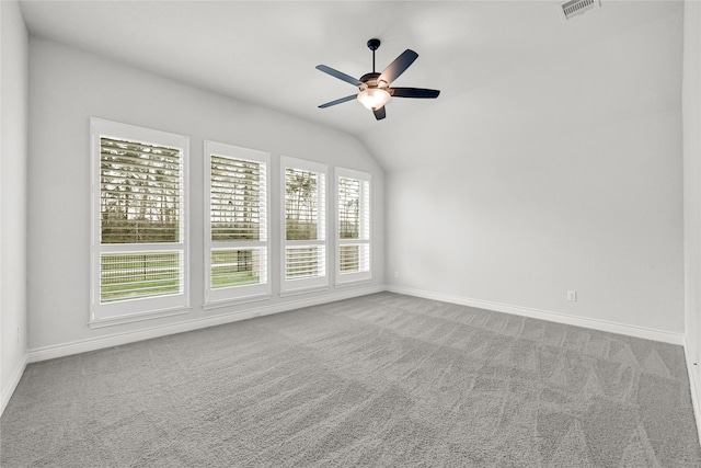 spare room featuring carpet flooring, visible vents, and a wealth of natural light