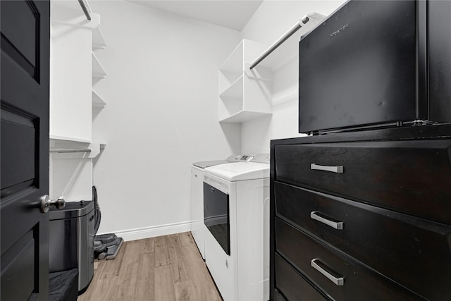 spacious closet with independent washer and dryer and light wood-style flooring