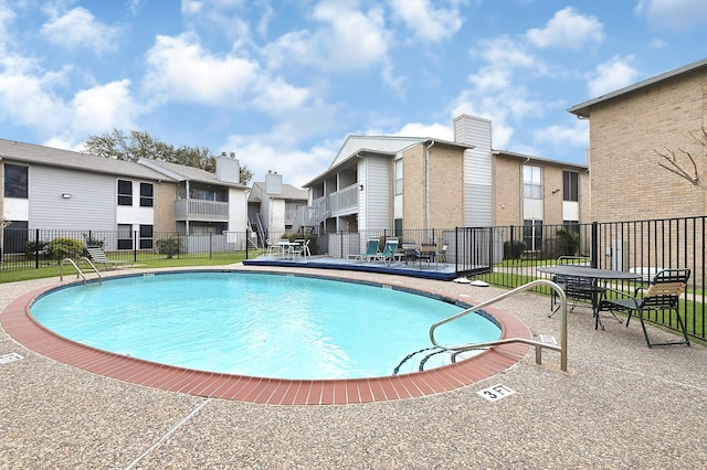 pool with a residential view and fence