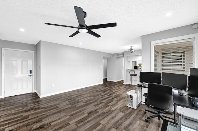 office space featuring baseboards, a textured ceiling, dark wood-type flooring, and ceiling fan