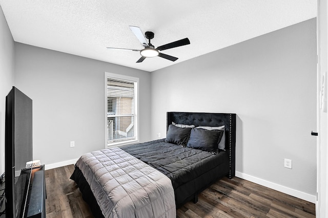 bedroom featuring ceiling fan, wood finished floors, baseboards, and a textured ceiling