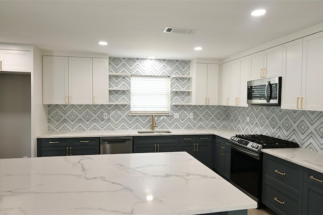 kitchen featuring visible vents, white cabinets, appliances with stainless steel finishes, and a sink