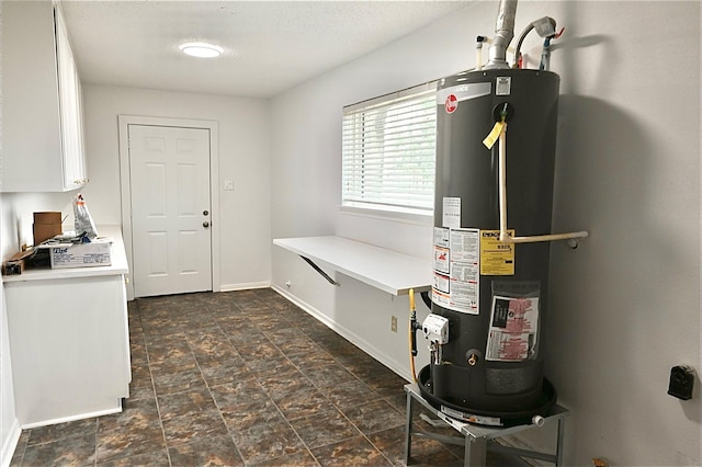 utility room featuring water heater