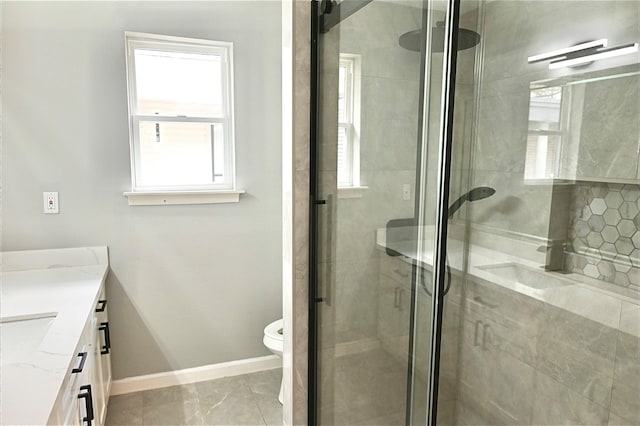 full bathroom featuring baseboards, toilet, a shower stall, and vanity