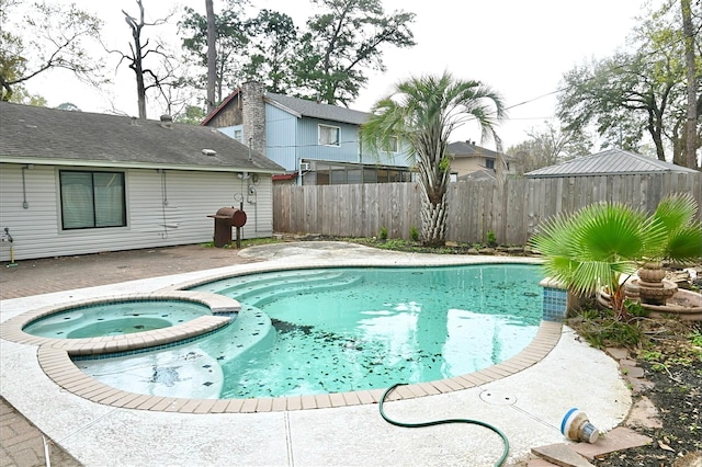 view of swimming pool featuring a patio area, a pool with connected hot tub, and fence