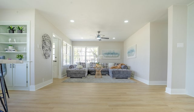 living area with recessed lighting, a ceiling fan, light wood-style floors, and baseboards