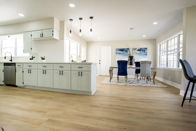 kitchen featuring a sink, dishwasher, light wood-style flooring, and recessed lighting