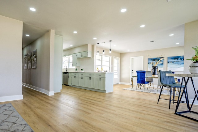 kitchen featuring a sink, recessed lighting, light wood-type flooring, and stainless steel dishwasher