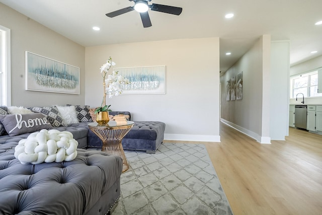 living room featuring recessed lighting, light wood-type flooring, baseboards, and a ceiling fan