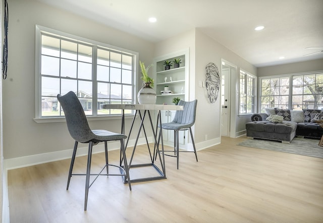 dining space featuring wood finished floors, baseboards, and a wealth of natural light