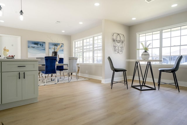 dining room with recessed lighting, baseboards, and light wood finished floors