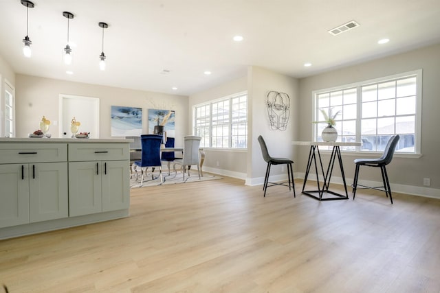 interior space with light wood-style flooring, recessed lighting, visible vents, and baseboards