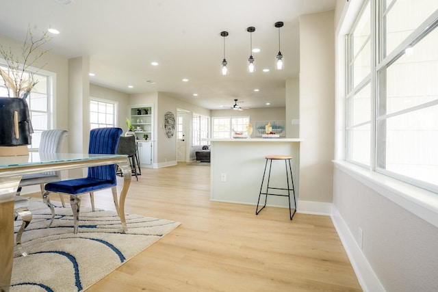 kitchen with baseboards, light wood-style flooring, recessed lighting, ceiling fan, and open floor plan