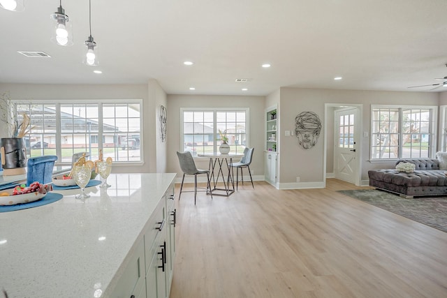 kitchen featuring decorative light fixtures, recessed lighting, light wood finished floors, and ceiling fan