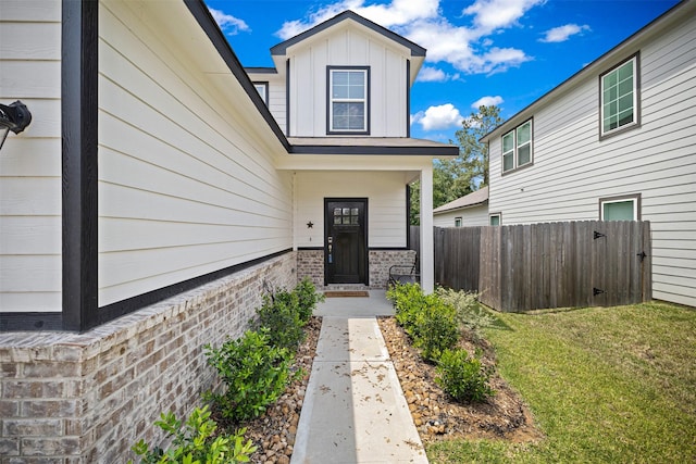 10718 Soapberry Ct, Tomball, TX 77375 - property entrance with brick siding, board and batten siding, fence, and a yard