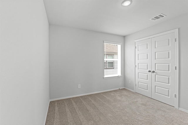 10718 Soapberry Ct, Tomball, TX 77375 - unfurnished bedroom featuring a closet, baseboards, carpet flooring, and visible vents