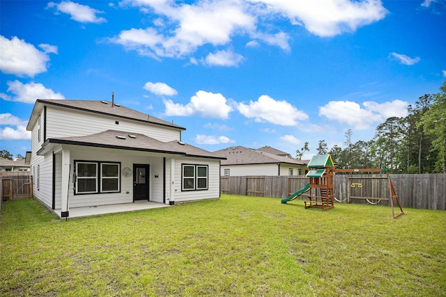 10718 Soapberry Ct, Tomball, TX 77375 - back of house featuring a lawn, a patio, a fenced backyard, and a playground