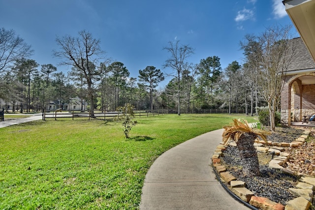 exterior space with a lawn and fence