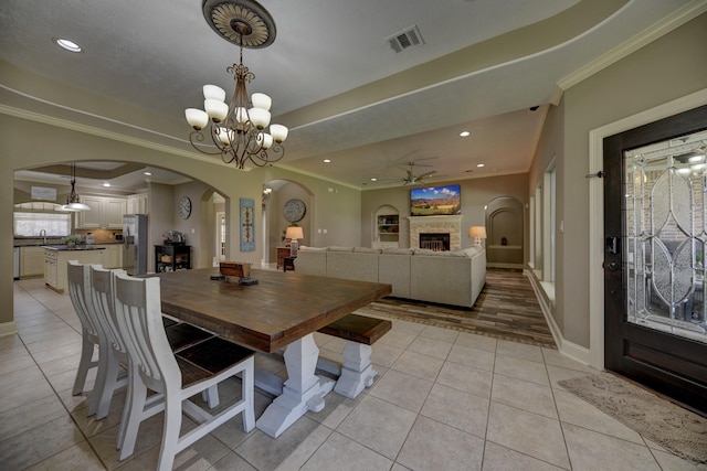 dining room featuring arched walkways, visible vents, and ornamental molding