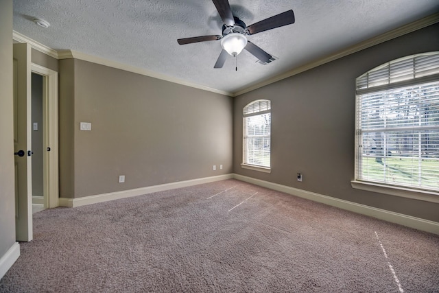 carpeted empty room featuring a textured ceiling, baseboards, ceiling fan, and ornamental molding