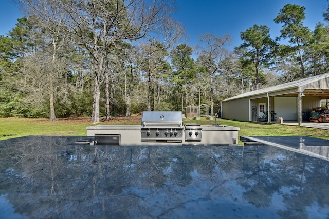 view of patio / terrace with a sink, exterior kitchen, and a grill