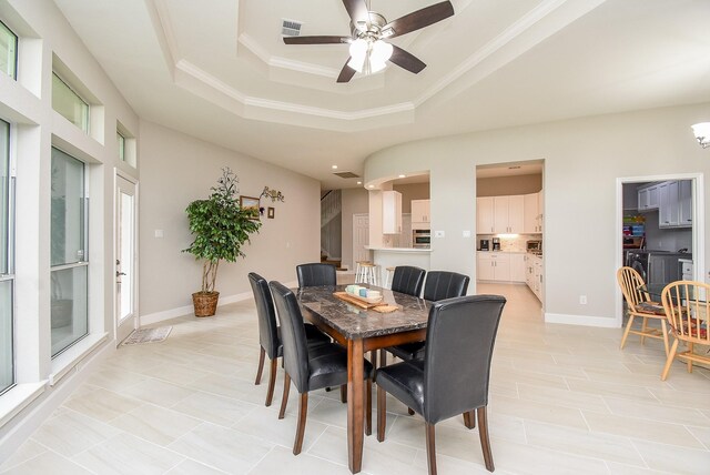 3211 Riviera Dr, Sugar Land, TX 77479 - dining area featuring a tray ceiling, baseboards, visible vents, and ceiling fan
