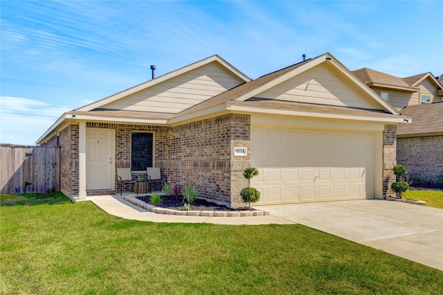 ranch-style house featuring a front yard, fence, driveway, an attached garage, and brick siding