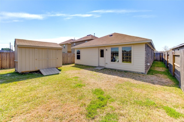 back of property with a fenced backyard, an outdoor structure, and a shed