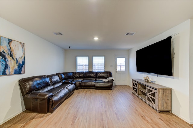 living room with visible vents, light wood-type flooring, and baseboards