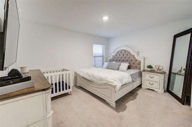 bedroom with recessed lighting and light colored carpet