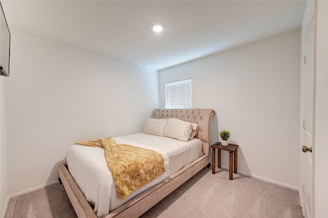 bedroom featuring recessed lighting, light colored carpet, and baseboards