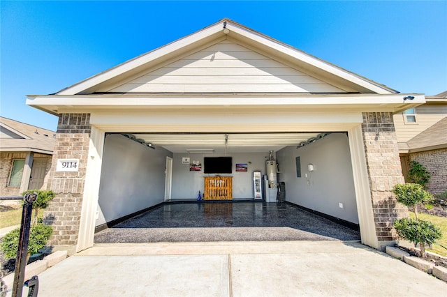 garage with gas water heater and driveway