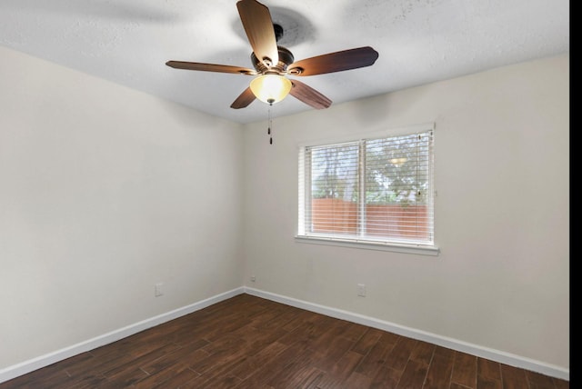 unfurnished room with dark wood-style floors, baseboards, and ceiling fan