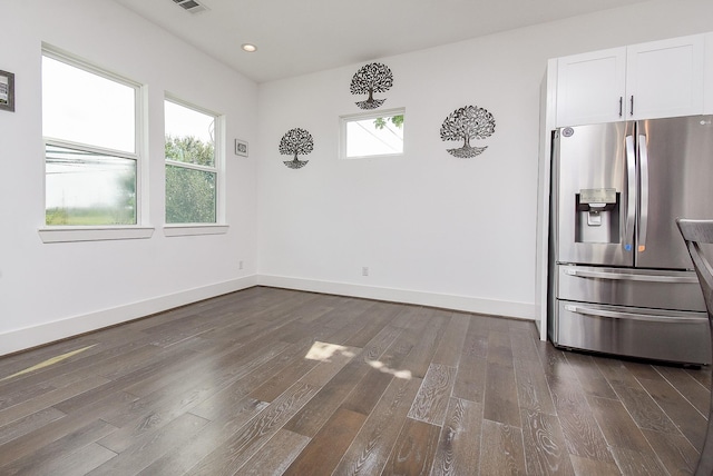 unfurnished dining area with a wealth of natural light, baseboards, dark wood-type flooring, and recessed lighting