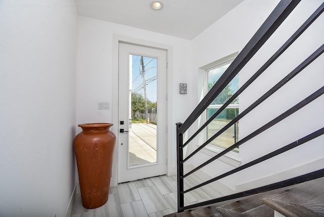 doorway to outside featuring stairway