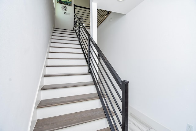 staircase featuring baseboards