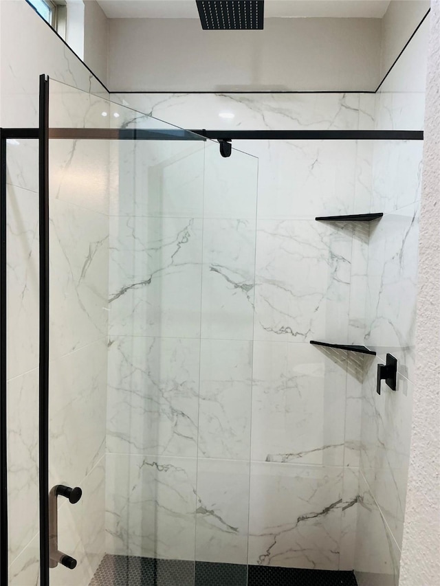 full bathroom with a marble finish shower