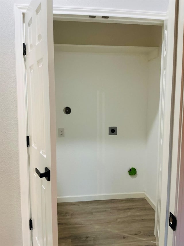 washroom featuring laundry area, wood finished floors, baseboards, and electric dryer hookup