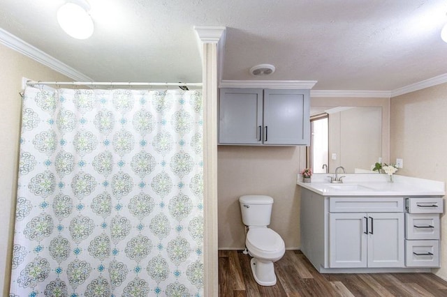 bathroom featuring toilet, crown molding, and wood finished floors