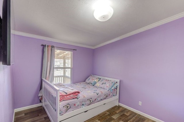 bedroom with baseboards, wood finished floors, and ornamental molding