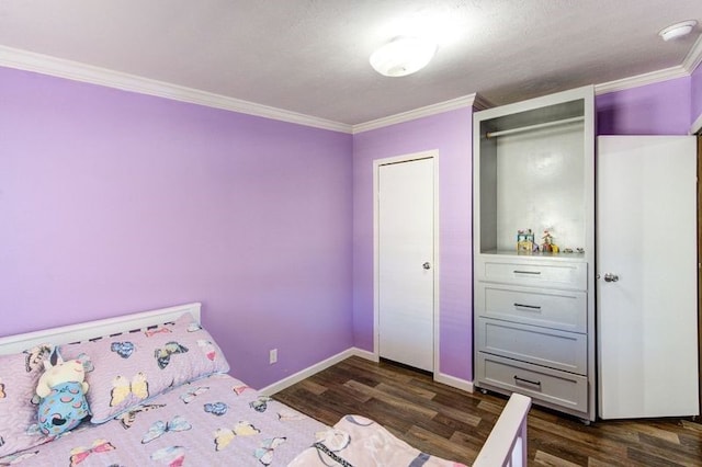 bedroom with dark wood finished floors, crown molding, and baseboards