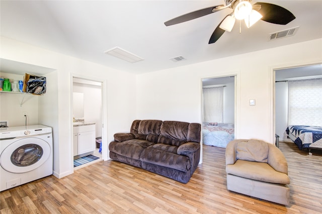 living area with washer / clothes dryer, a ceiling fan, visible vents, and light wood-type flooring